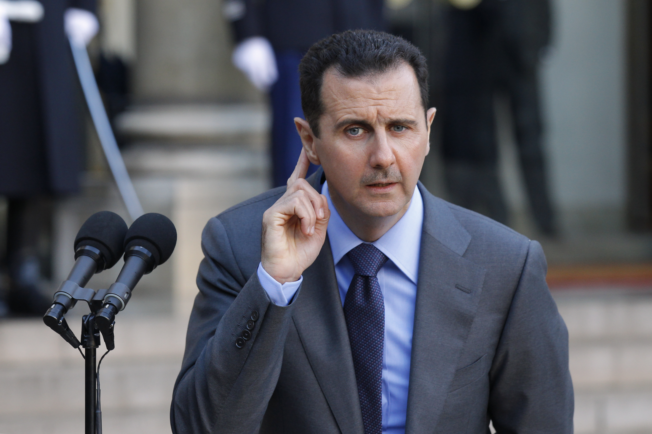 Syria's President Bashar al-Assad answers journalists after a meeting at the Elysee Palace in Paris, December 9, 2010. REUTERS/Benoit Tessier (FRANCE - Tags: POLITICS)